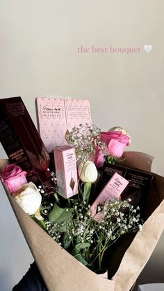 a bouquet of flowers and chocolates in a brown paper bag with the words the best bouquet written on it