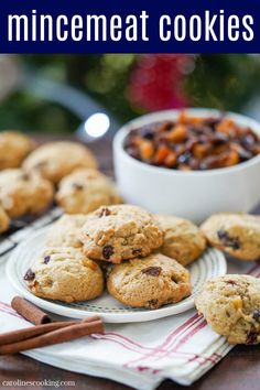 chocolate chip cookies on a plate with cinnamon sticks and bowl of raisins in the background