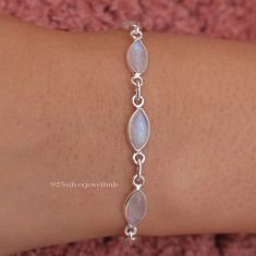 Rainbow Moonstone Bracelet, 925 Solid Sterling Silver Bracelet, June Birthstone, Handmade Bracelet, Cabochon Jewelry, Women Silver Bracelet Gemstone Name - Rainbow Moonstone  Stone Quality - AAA Bracelet Weight - 5.22 gm Stone Length - 0.8 cm , Stone Width - 0.4  cm 6 inch to 9 inch sizes are available, we give 0.5 inch adjustable in the size which you order ( NOTE - 0.5 INCH ADJUSTABLE IS INCLUDED IN YOUR ORDERED SIZE ) Stone Shape - As shown in the picture You'll get the exact product as shown in the pictures We serve complete 925 sterling silver Jewelry and genuine properties of the stone. The products are dispatched from the small business from USA. Product Quality and Packaging - Our all products are 925 Silver Stamped which shows that the product is genuine and authentic .The product Moon Stone Bracelet Jewelry, Sterling Silver Bracelet With Gemstone And Moonstone, Silver Dainty Gemstone Bracelets, White Gemstone Bracelet In Sterling Silver, Silver Dainty Gemstone Bracelet, Dainty Silver Bracelet With Gemstone, White Sterling Silver Bracelet With Gemstone, White Sterling Silver Gemstone Bracelet, Dainty Silver Gemstone Bracelet