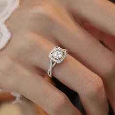 a woman's hand with a diamond ring on it