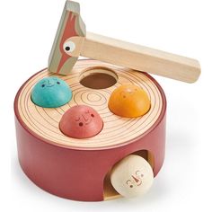 a wooden toy with four different colored rocks