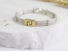 Stop looking for the ultimate bracelet. You just found it. This Greek Key bracelet made from 925 sterling silver combined with 18k gold to bring out this unique look ! Handcrafted with attention to detail, this meander wide  bracelet will make the perfect gift for you or someone special! Inspired from the Ancient Greek times this wheat chain bracelet it's a must have jewelry piece.  Items Details:  - Materials: 18K Gold & 925 Sterling Silver -Bracelet Width: 6.15mm -Lobster Claw Clip -->Made to Sterling Silver Byzantine Bracelets For Gifts, Sterling Silver Byzantine Bracelet Gift, Sterling Silver Byzantine Bracelet, Byzantine Box Chain Bracelets As Gifts, Byzantine Box Chain Bracelet As Gift, Byzantine Box Chain Bracelet For Gift, Byzantine Style Jubilee Bracelet As Gift, Byzantine Jubilee Bracelet As Gift, Must Have Jewelry