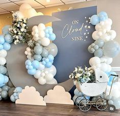 a baby's carriage and balloons are on display