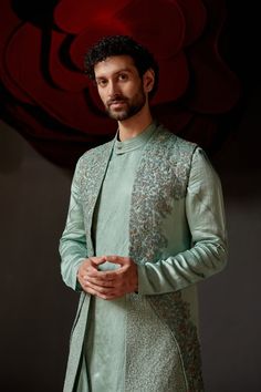 Smokey Pallid Shrug Set | Jatin Malik Introducing our best-seller in chateau grey, now reimagined in a stunning paneled shrug. This elegant piece is hand-embroidered using two distinct zardozi techniques, featuring intricate resham and gold work for a rich, textured finish. Paired with a matching tone-on-tone drape kurta and tapered trousers, this ensemble exudes sophistication and refined style. Perfect for making a statement at any special occasion, this outfit showcases the finest craftsmanship and timeless elegance. Included in purchase: Shrug Set, Kurta, Trousers Product Specification Color: Chateau Grey Fabric: Linen Silk Occasion: Engagement, Wedding, Bridal, Reception Style: Shrug Set, Kurta, Trousers Care: Dry Clean Work: Hand Embroidery Customization options:Can be customized in Jatin Malik, Blouse Yoke, Haldi Outfit, Kurta Men, Wedding Outfit Men, Royal Look, Indian Man, Indian Groom, Tapered Trousers