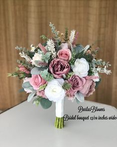 a bridal bouquet with pink and white flowers