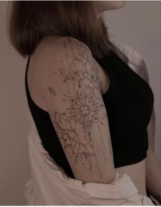 a woman with a flower tattoo on her arm