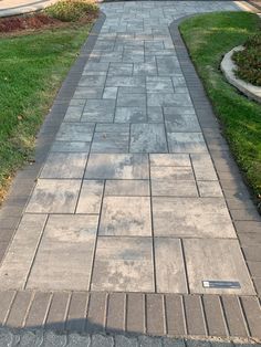 an empty sidewalk in front of a house