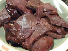 sliced meat on a plate with brown sauce