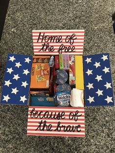 a sign that says home of the free because of the brave with some items in it