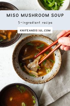 someone holding chopsticks over a bowl of miso mushroom soup