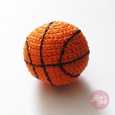 an orange crocheted basketball sitting on top of a white table