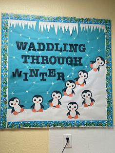 a bulletin board with penguins on it and the words wadding through winter written below