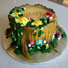 a cake decorated with flowers and leaves on a plate