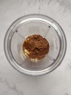 an overhead view of a blender filled with brown powder and other things in it