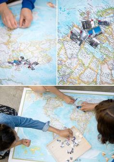 two girls are playing with magnets on a map