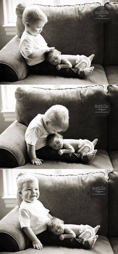 two young boys sitting on the back of a couch playing with each other's hands