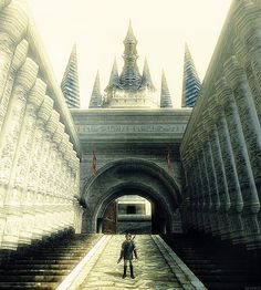 an image of a man standing in the middle of a tunnel that leads to another building