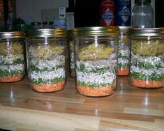 four mason jars filled with different types of food