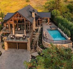 an aerial view of a house with a pool and hot tub in the backyard area