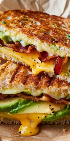 a grilled cheese sandwich with bacon, lettuce and cheddar on it