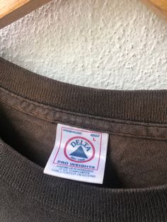 a label on the back of a brown shirt