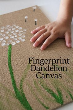 a child's hand on top of a canvas with the words fingerprint dandelion canvas