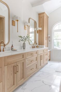 a large bathroom with two sinks and mirrors