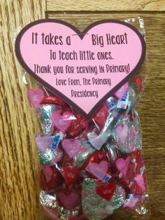 a bag filled with lots of pink and red hearts