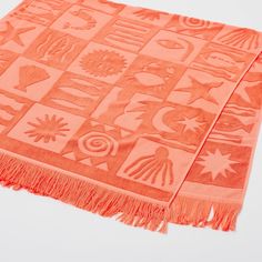 an orange rug with many different designs on it