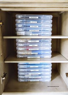 several plastic containers are stacked on top of each other in an open shelving unit