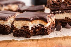 chocolate and marshmallow brownies are stacked on top of each other with one bite taken out