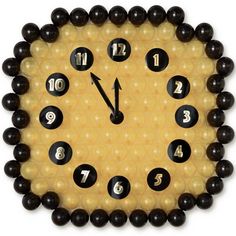 a clock made out of black and yellow beads with numbers on the face, around it is an eight o'clock