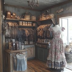 an old fashioned clothing store with clothes on display