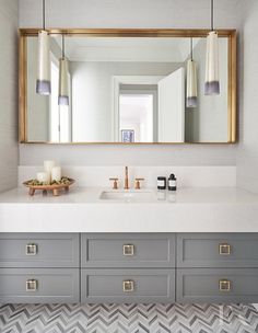 a bathroom vanity with two sinks and a large mirror