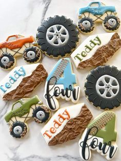 decorated cookies are arranged on top of a marble countertop with tractor and farm words