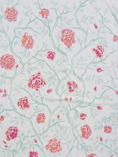 a pink and green floral print on white fabric