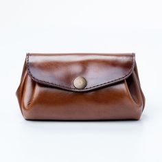 This stylish and unique brown leather wallet is perfect for the modern woman on the go! Crafted from high-quality leather, this wallet is designed to look like a bun and features multiple compartments to keep your cards, cash, and other items organized. The wallet also comes with an attachable wristlet strap, making it easy to carry around with you wherever you go. With its classic design and practical features, this small leather wallet is the perfect accessory for any woman! Our best-selling, Modern Brown Clutch For Daily Use, Brown Business Wallets Pouch, Brown Travel Coin Purse With Card Slots, Modern Brown Trifold Wallet For Travel, Versatile Brown Clutch For Travel, Versatile Brown Wallet With Removable Pouch, Brown Bifold Coin Purse For Travel, Versatile Brown Wallet For Everyday Use, Versatile Leather Clutch Wallet