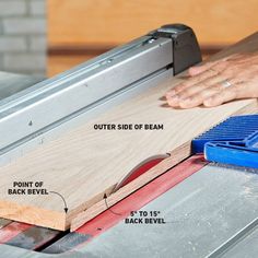 a person using a table saw to cut planks on a piece of plywood