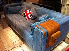 a denim couch with a union jack pillow on it