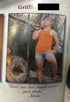 a man in an orange shirt is holding a stick and posing for the camera with his hands on his hips