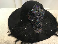 New York Paris Mr. John Classic Black sequin feathered hat. 22 in circumference 5 in deep Winter Party Hats With Feathers, Evening Costume Hat With Feathers, Winter Party Fedora Costume Hat, Party Winter Mini Hat With Flat Brim, Brimmed Costume Hats For Fall Parties, Short Brim Costume Hats With Feather Trim For Party, Wide Brim Costume Hats For Fall Parties, Feathered Evening Hat For Carnival, Costume Hats And Headpieces With Feather Trim For Party