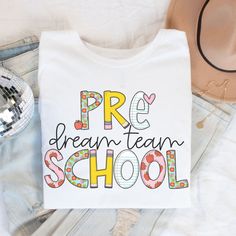 a t - shirt with the words pre dream team school on it next to jeans and a hat