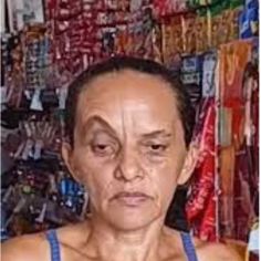 an older man with wrinkles on his face in front of a store filled with items