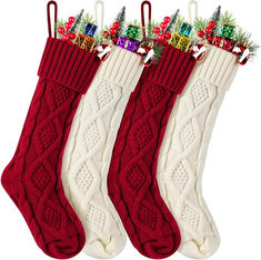 three stockings with christmas decorations hanging from them