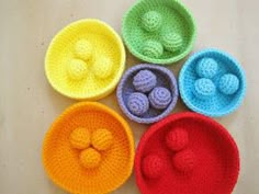 four crocheted bowls are shown with balls in the middle and one is empty