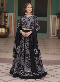 Get ready to make a statement in our Black Rayon Printed Lehenga Choli! Perfect for Indian weddings, parties, receptions, or any special occasion. This ready-to-wear piece is designed to enhance your style and confidence. Stand out with this elegant guest wear lehenga choli and be the center of attention! The unstitched blouse can be customized upto 46 inches. Do Note: All the accessories shown are for styling purpose only. Slight color variation may occur due to photographic reasons. Occasion : Wedding, Party, Function, Festival, Navratri, Diwali, Durga Pooja, Nikah Special, Bridal Wear Includes : 1 Lehenga, 1 Blouse, 1 Dupatta Blouse Piece : 1.0 meter Lehenga Fabric: Rayon Blouse Fabric: Rayon Dupatta Fabric: Rayon Lehenga Color: Black Blouse Color: Black Dupatta Color: Black Wash Instru Partywear Lehenga, Wedding Lehenga Choli, Ghaghra Choli, Indian Wedding Lehenga, Lehenga Choli For Women, Choli For Women, Printed Lehenga, Follow Photo, Rayon Blouse