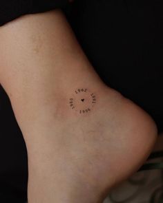 a small tattoo on the back of a woman's leg that reads love is in the air