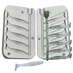 two metal trays with toothbrushes on them next to a plastic brush holder