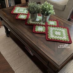 three potted plants on top of a coffee table