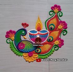 this is an image of a colorful diya with peacocks and flowers on it